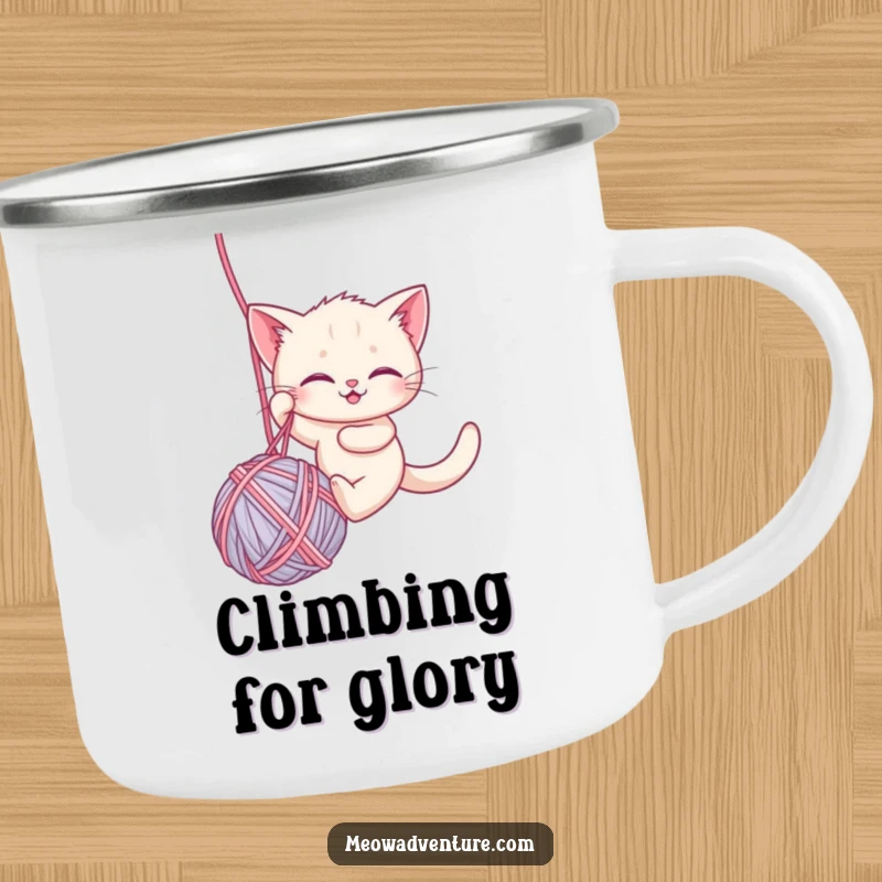 Funny camping mug showing a brave kitten rappelling down a ball of yarn, perfect for enjoying drinks on the go with a humorous touch.