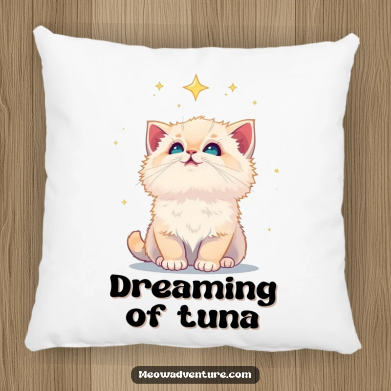Funny fluffy kitten looking up at a star-filled sky, featured on a plush pillow, perfect for sweet dreams.