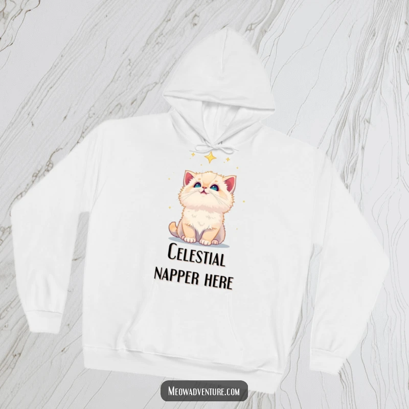 Funny fluffy kitten looking up at a vast, starry night sky, featured on a soft hoodie, evoking wonder and peace.