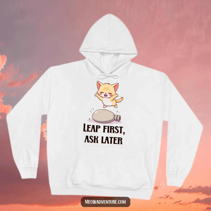 Funny kitten hoodie, a joyful cat captured mid-leap over a fallen item, showcasing a hilarious and acrobatic moment.