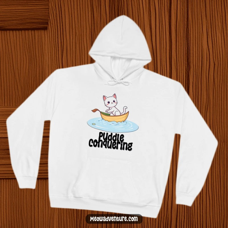Funny hoodie with an adventurous cat sailing on a leaf boat, designed for warmth and celebrating the spirit of exploration.