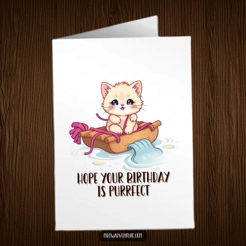 Funny Free Printable Birthday Card featuring a fluffy kitten sailing a yarn raft down a stream, full of cozy charm.