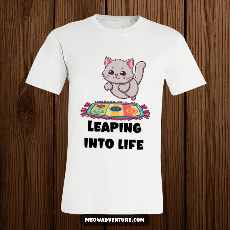 Funny Cat Rug Leap T-Shirt depicting a fluffy grey cat energetically leaping onto a colorful rug, showcasing playful movement.