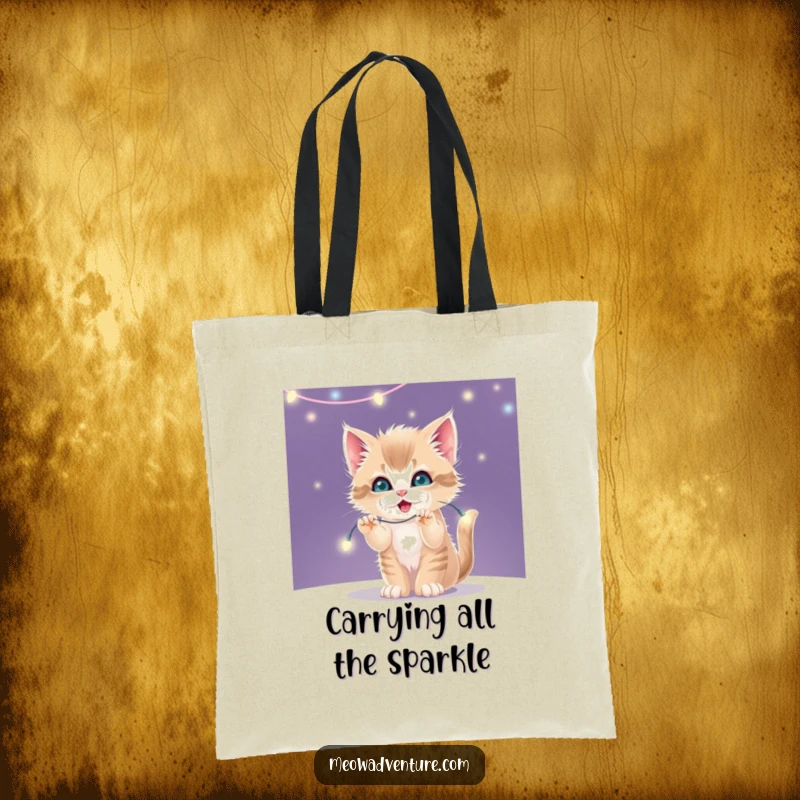 Funny canvas tote bag with a mischievous kitten playfully batting at a string of bright, twinkling fairy lights.