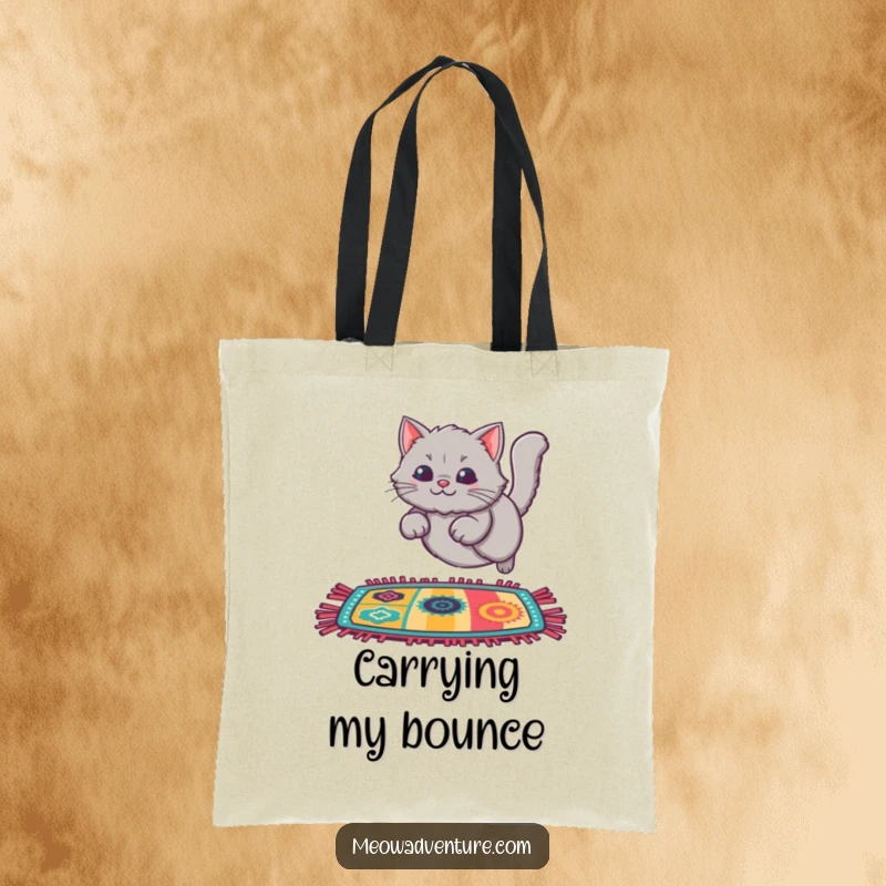 Funny Cat Rug Leap Tote Bag showing a fluffy grey cat leaping onto a colorful rug, perfect for carrying everyday essentials.