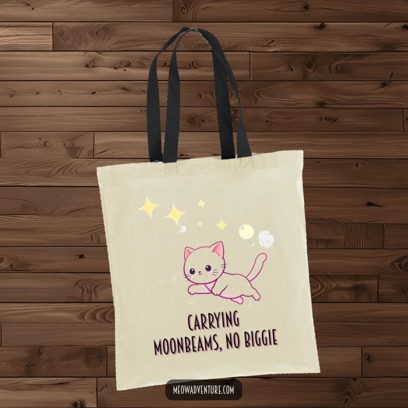 Funny canvas tote bag depicting a playful kitten leaping through a starry expanse, playfully chasing a luminous moonbeam.