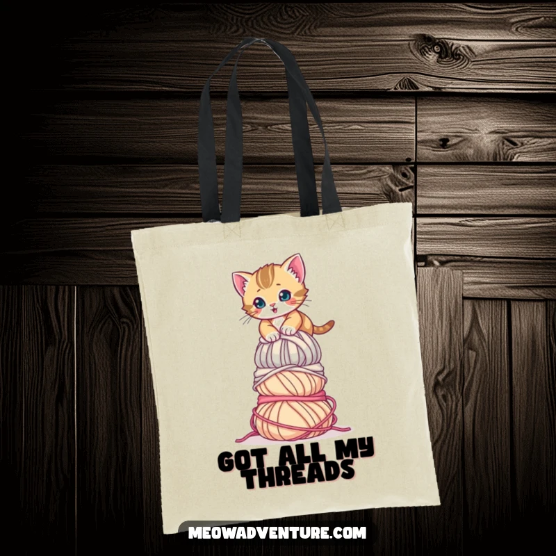 Funny Determined Kitten Yarn Tote Bag featuring a tenacious kitten scaling a towering pile of yarn. A humorous and functional bag.