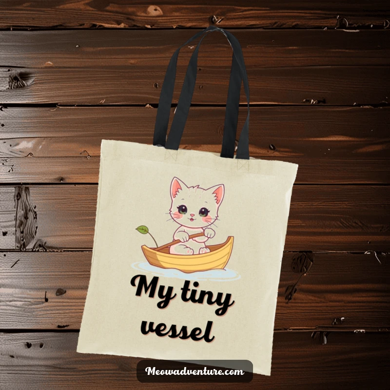 Funny tote bag with a kitten rowing a leaf boat, perfect for carrying essentials on any adventure with a smile.